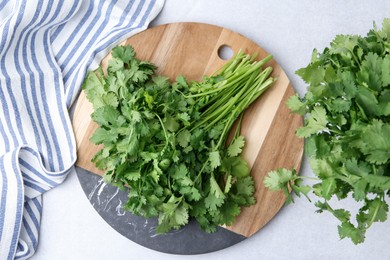 Photo of Fresh green cilantro on light table, flat lay