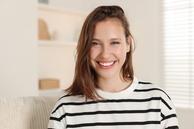 Photo of Portrait of smiling teenage girl at home