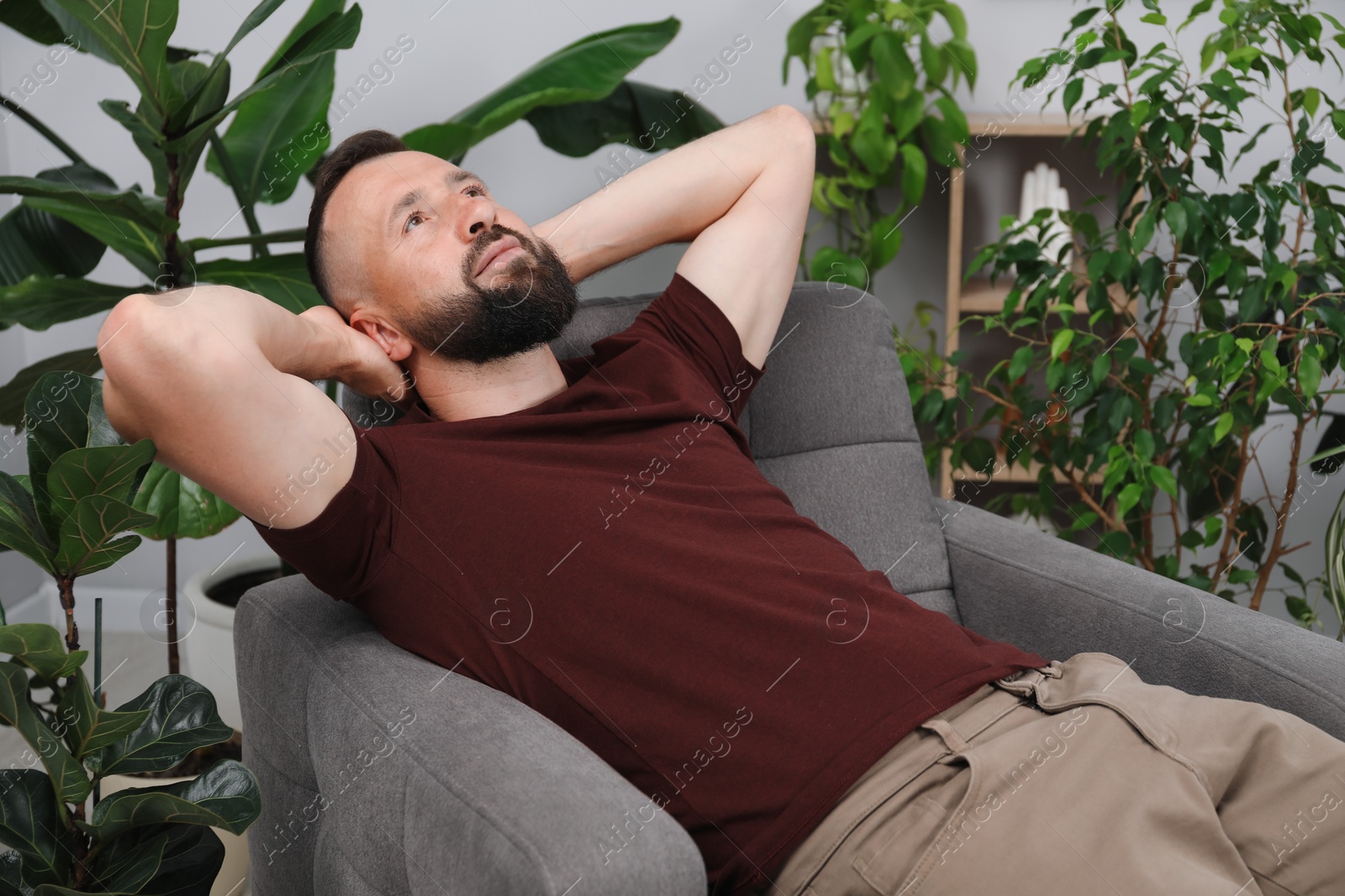 Harmony. Man relaxing in comfortable armchair at home Photo of Harmony. Man relaxing in comfortable armchair at home