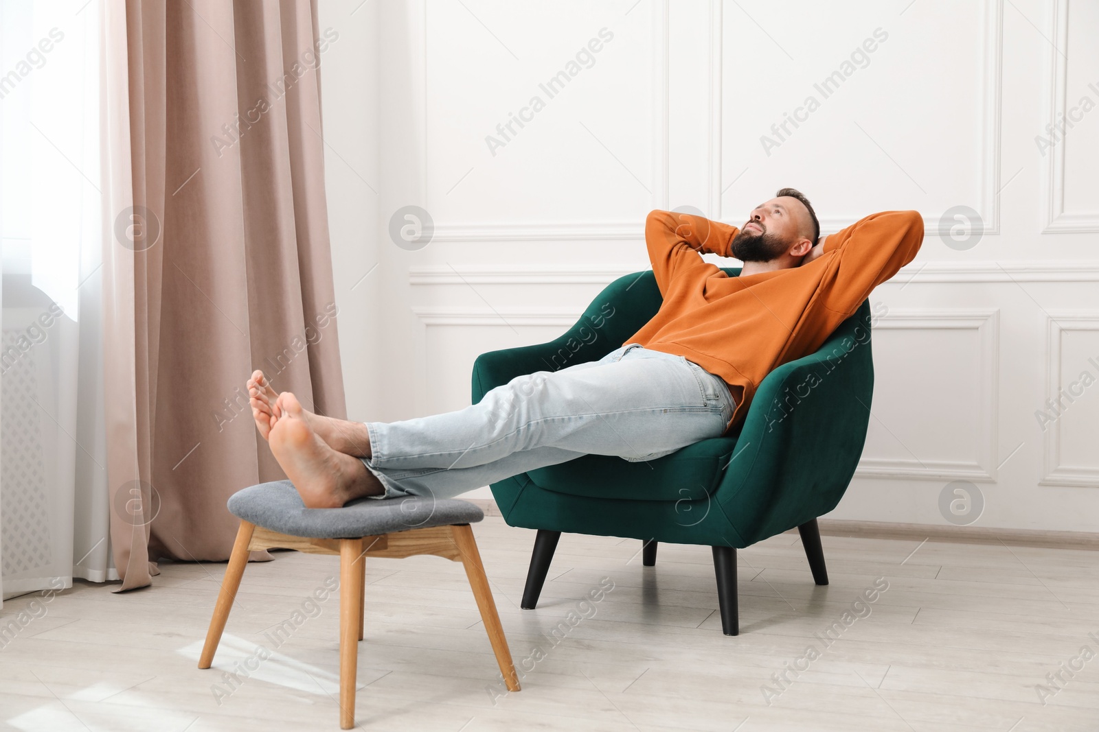 Harmony. Man relaxing in comfortable armchair at home Photo of Harmony. Man relaxing in comfortable armchair at home