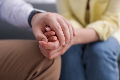 Photo of Psychologist supporting patient during therapy session in office, closeup