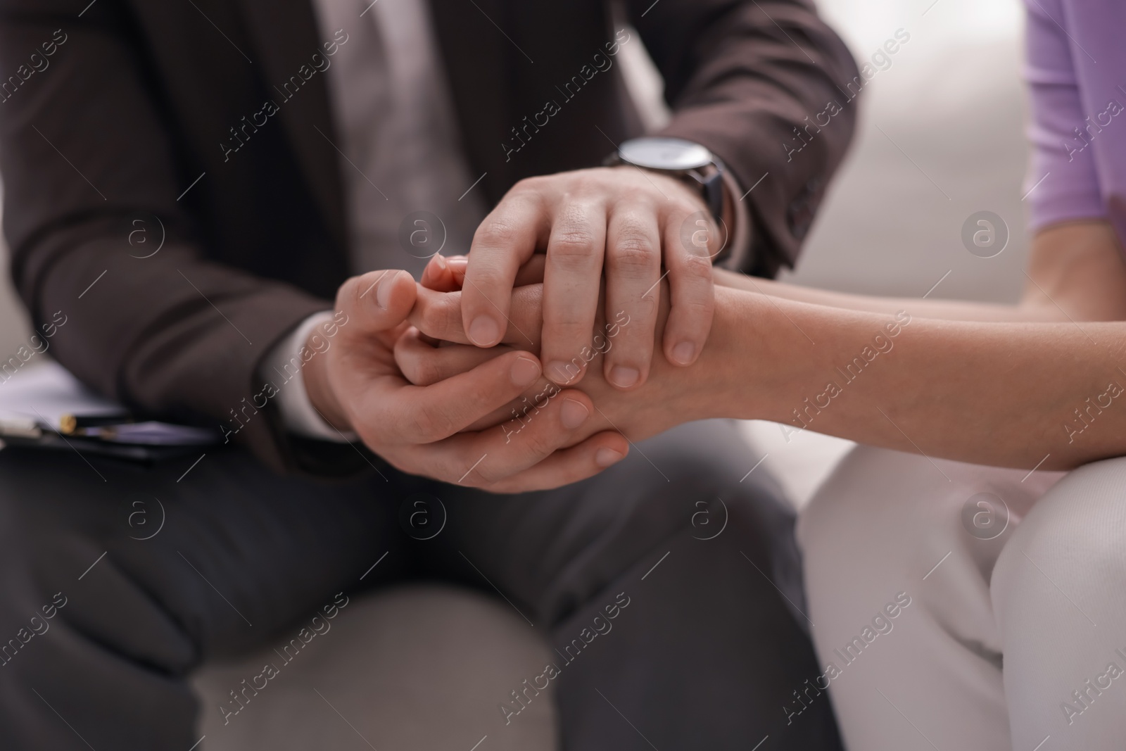 Psychologist supporting patient during therapy session on sofa in office, closeup Photo of Psychologist supporting patient during therapy session on sofa in office, closeup