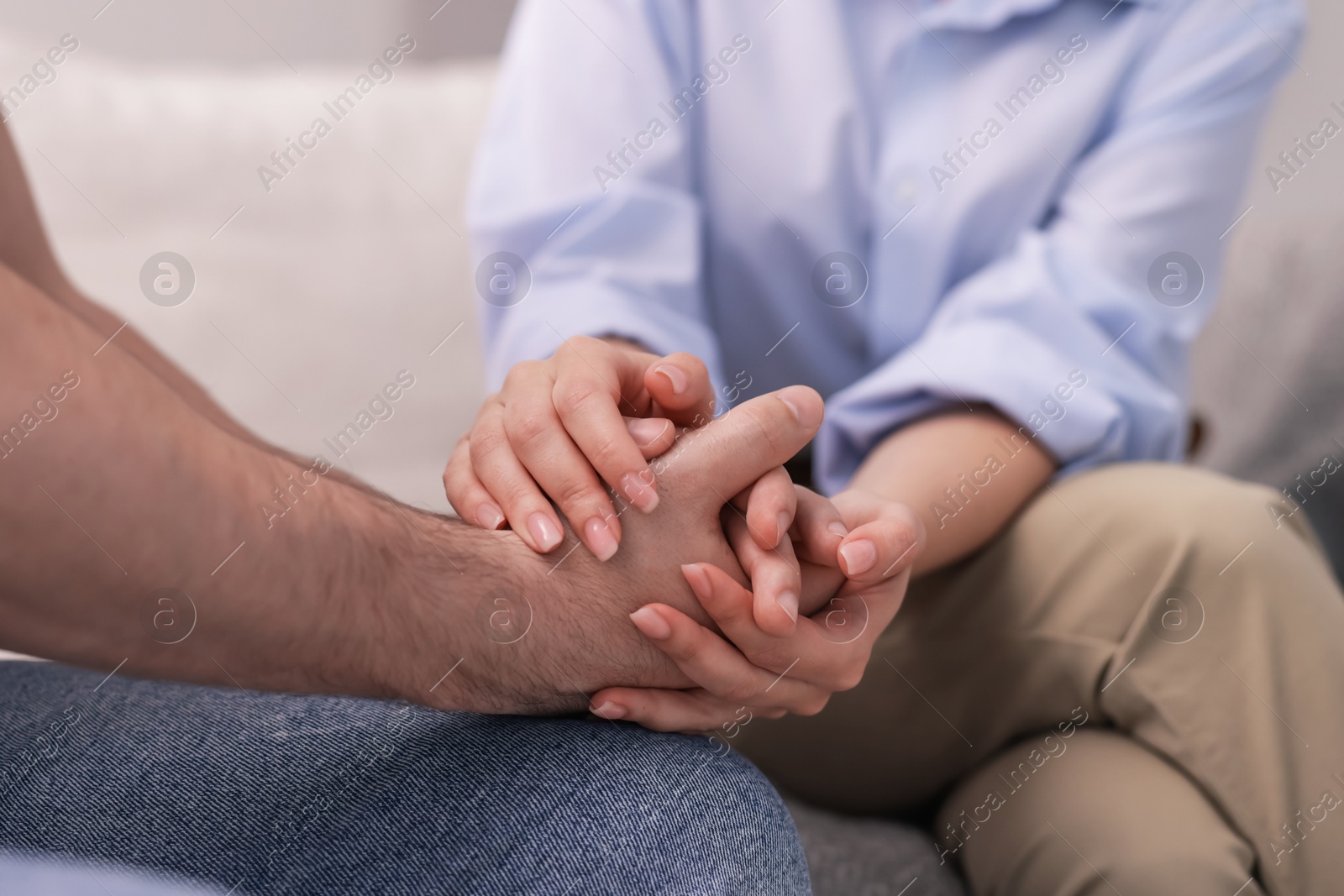 Psychologist supporting patient during therapy session on sofa in office, closeup Photo of Psychologist supporting patient during therapy session on sofa in office, closeup