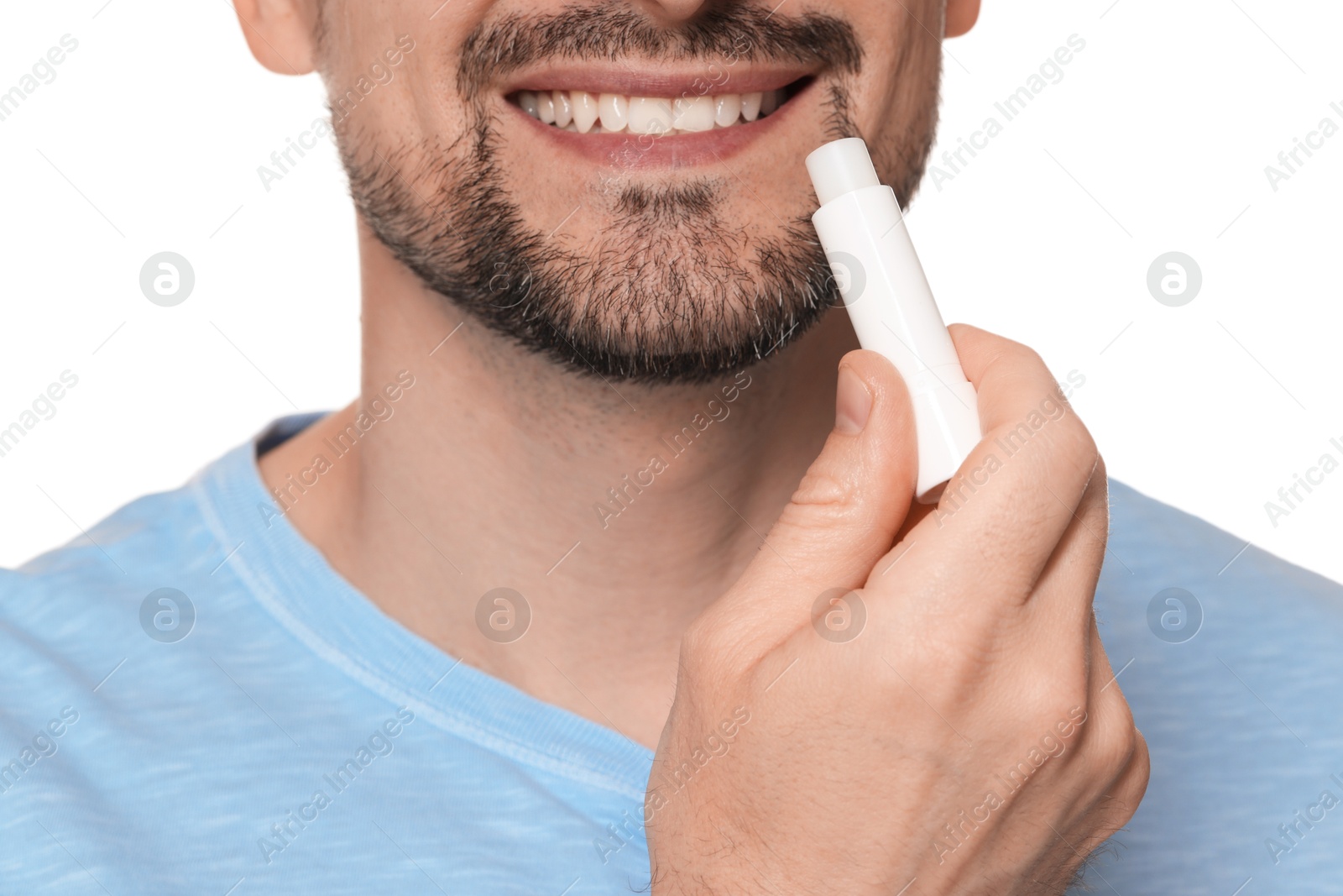 Smiling man applying lip balm onto his lips on white background, closeup Photo of Smiling man applying lip balm onto his lips on white background, closeup