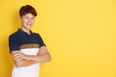 Photo of Portrait of teenage boy on orange background, space for text
