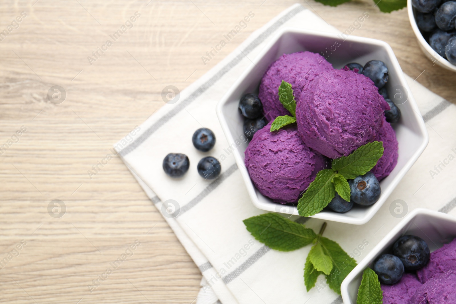 Tasty sorbet with blueberries and mint on wooden table, flat lay. Space for text Photo of Tasty sorbet with blueberries and mint on wooden table, flat lay. Space for text