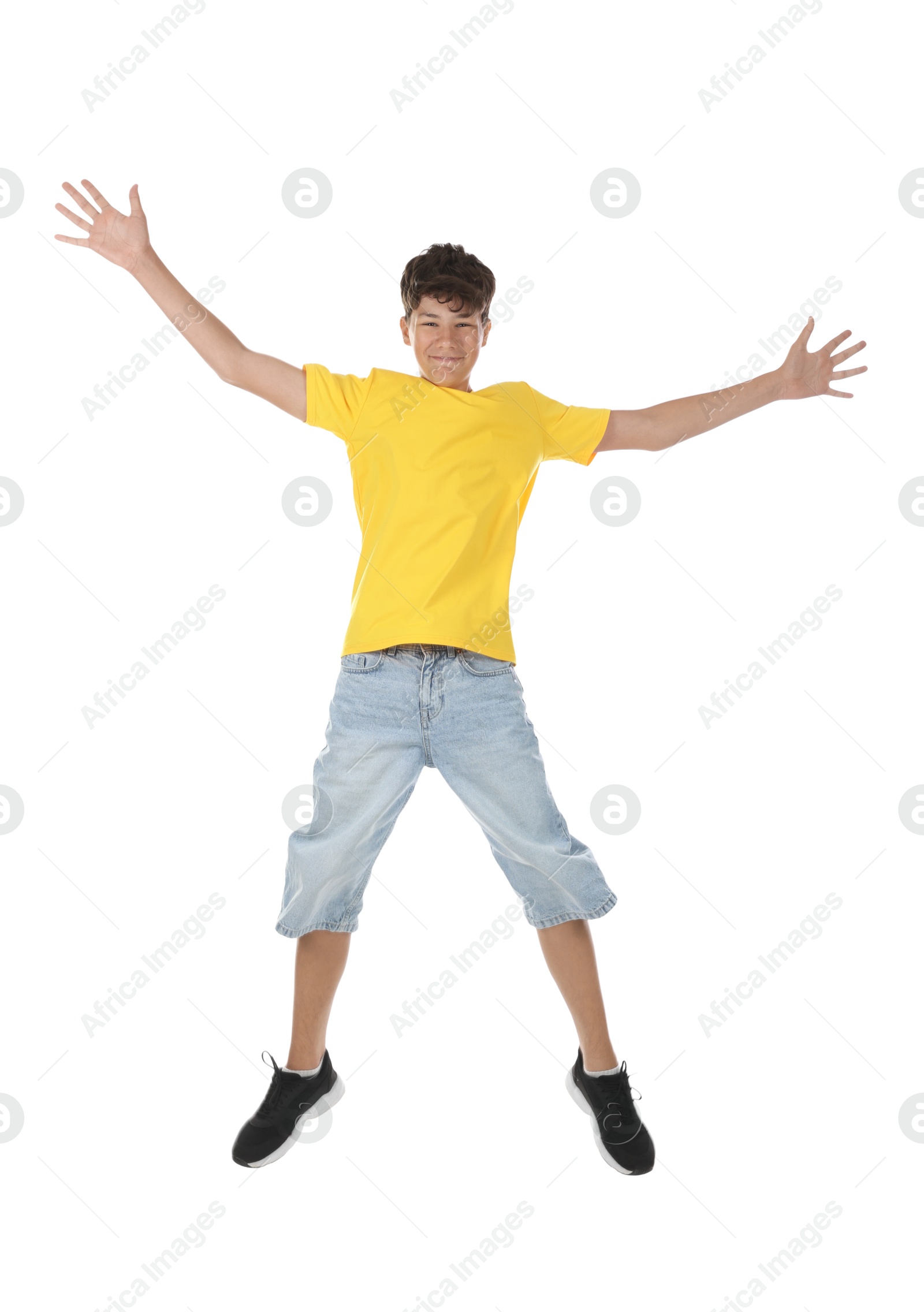 Portrait of teenage boy jumping on white background Photo of Portrait of teenage boy jumping on white background