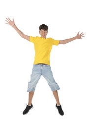 Photo of Portrait of teenage boy jumping on white background