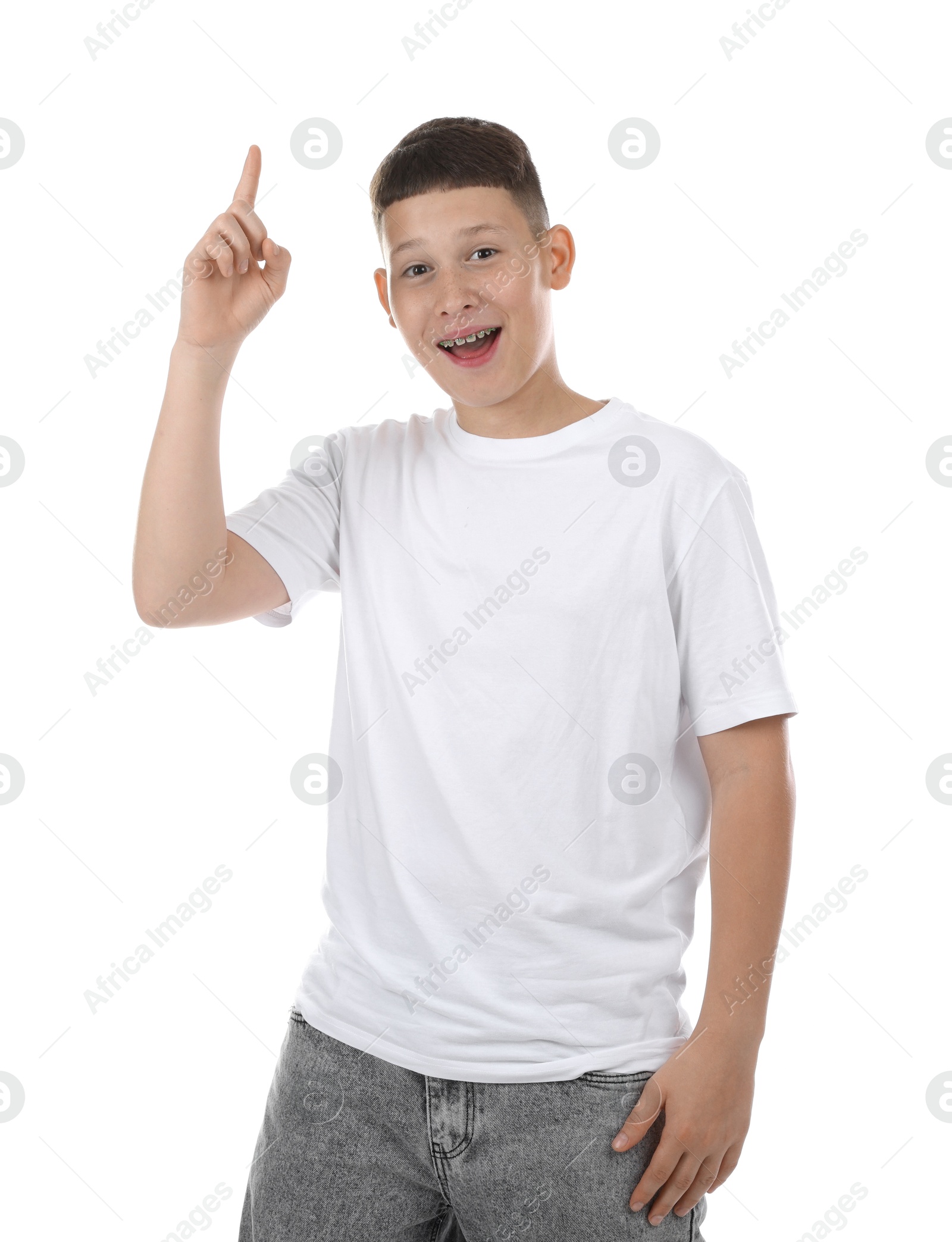 Teenage boy pointing at something on white background Photo of Teenage boy pointing at something on white background