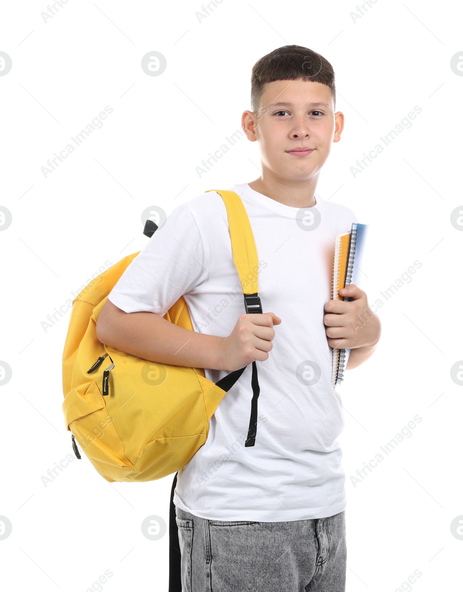 Teenage boy with notebooks and backpack on white background Photo of Teenage boy with notebooks and backpack on white background