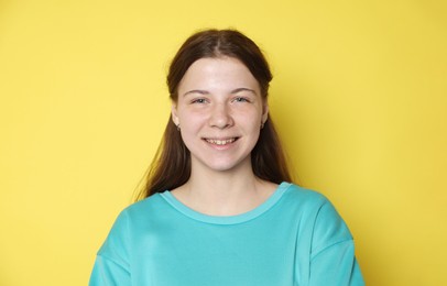 Photo of Portrait of teenage girl on yellow background