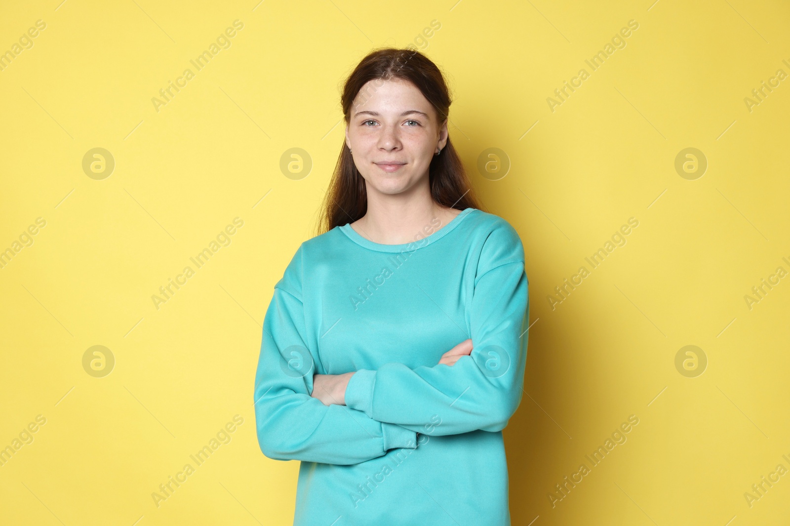 Portrait of teenage girl on yellow background Photo of Portrait of teenage girl on yellow background