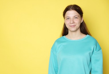 Photo of Portrait of teenage girl on yellow background, space for text