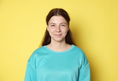 Photo of Portrait of teenage girl on yellow background