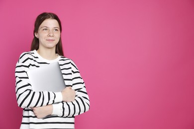 Photo of Teenage girl with laptop on crimson background, space for text