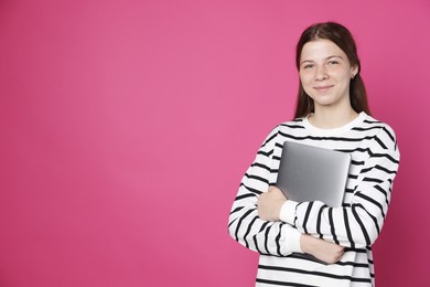 Photo of Teenage girl with laptop on crimson background, space for text