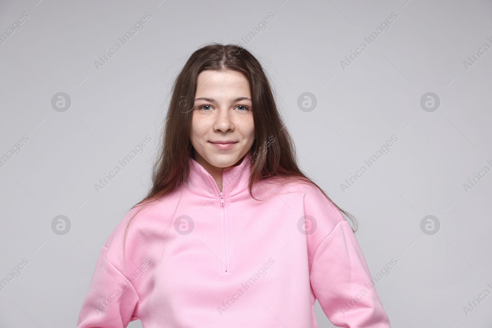 Portrait of teenage girl on light grey background Photo of Portrait of teenage girl on light grey background