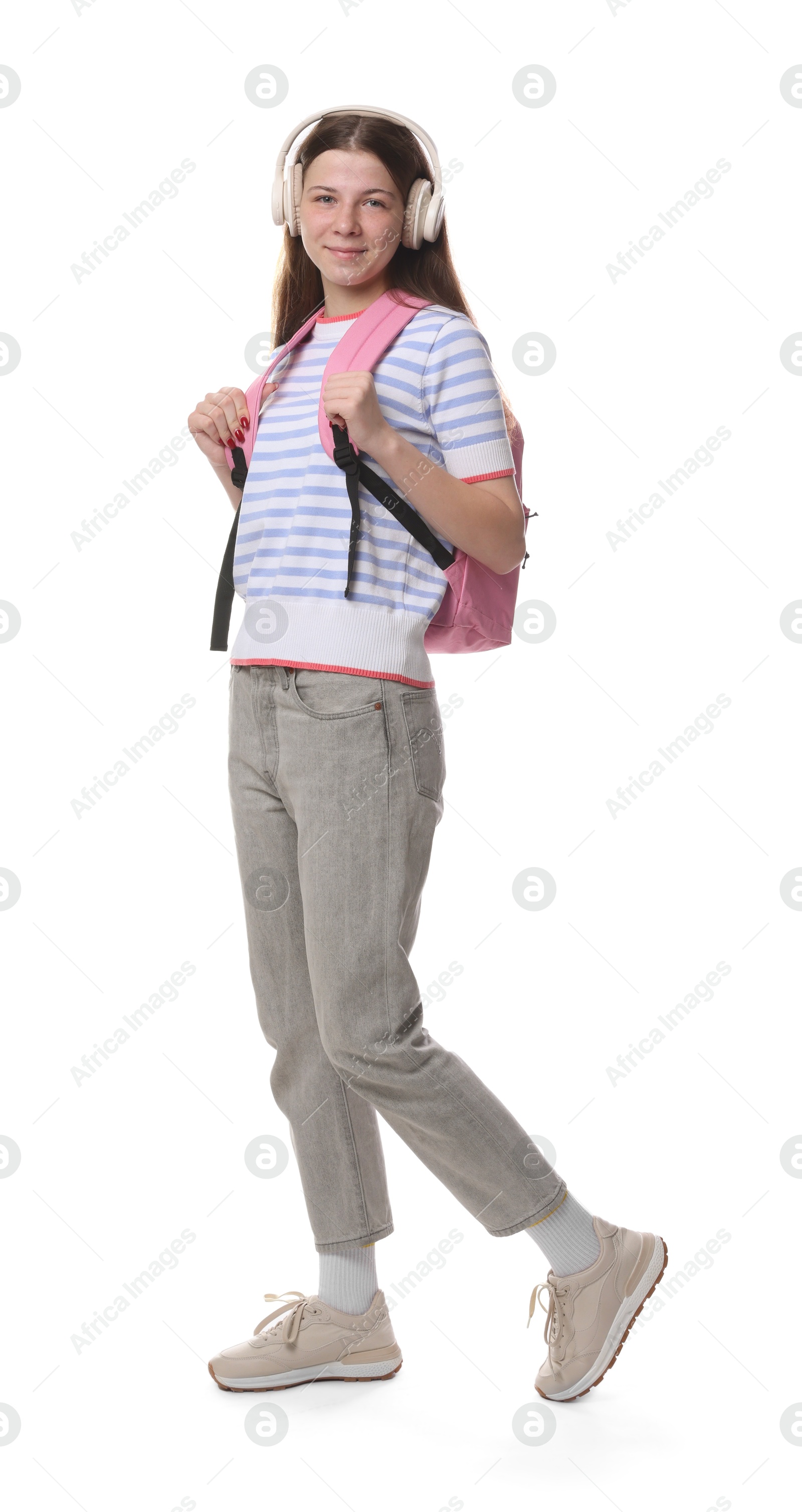 Teenage girl in headphones with backpack on white background Photo of Teenage girl in headphones with backpack on white background