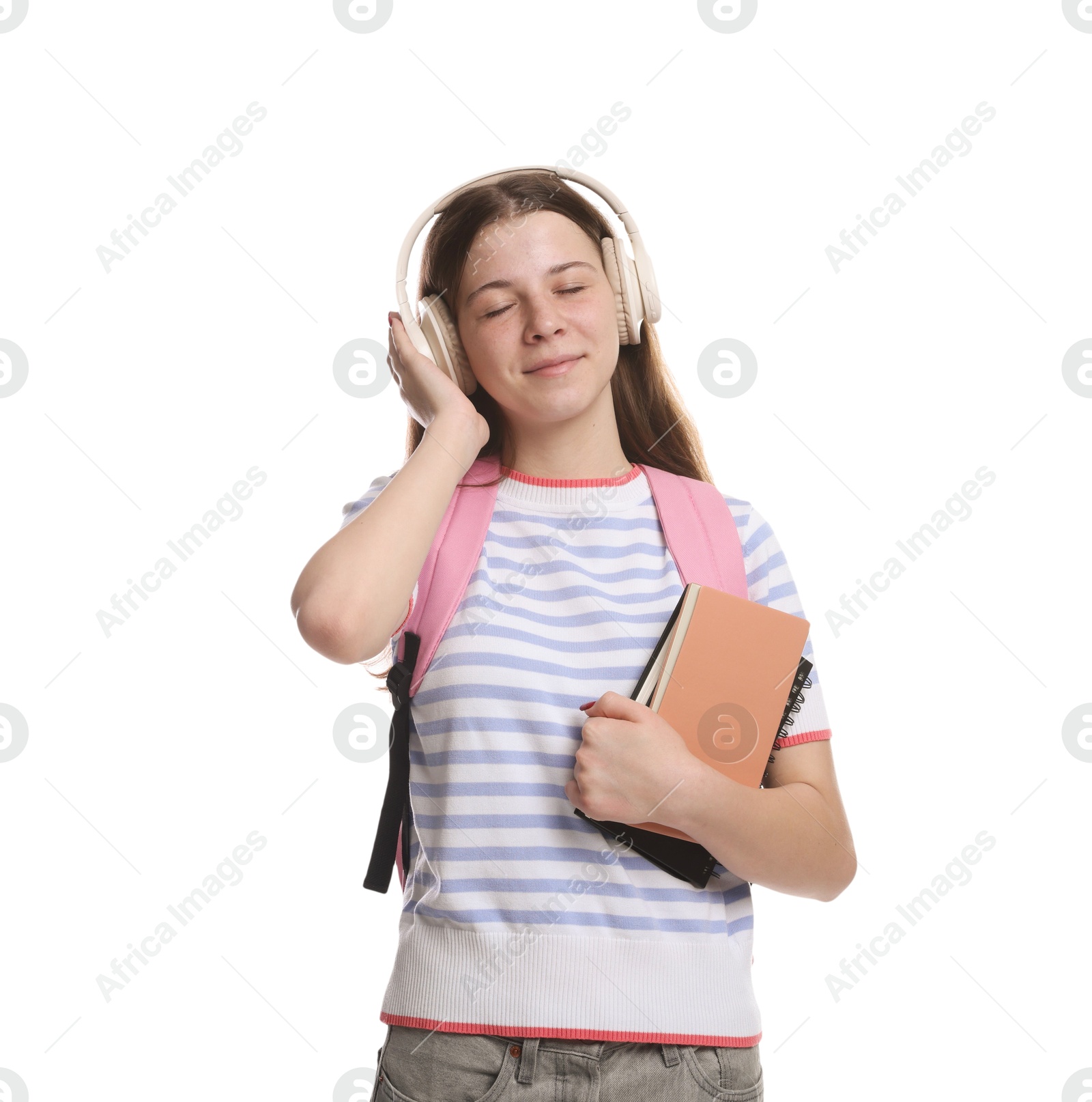 Teenage girl in headphones with backpack and notebooks on white background Photo of Teenage girl in headphones with backpack and notebooks on white background
