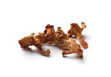 Photo of Many dried chanterelle mushrooms isolated on white