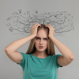 Image of Worried woman on grey background. Confused thoughts as doodles coming out of her head. Stress, anxiety, depression