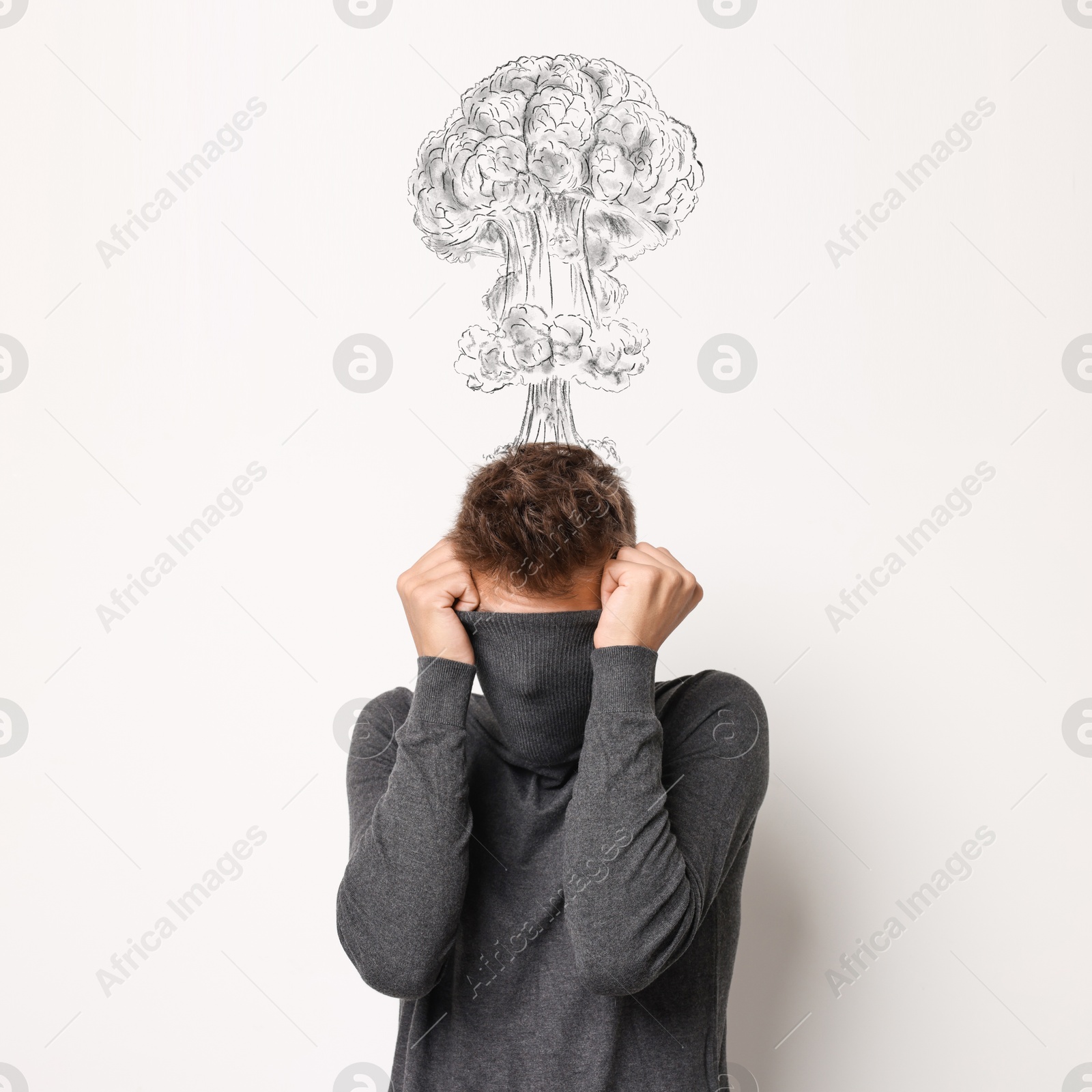 Worried man covering his face. Confused thoughts depicted by explosion on white wall behind him. Stress, anxiety, depression Image of Worried man covering his face. Confused thoughts depicted by explosion on white wall behind him. Stress, anxiety, depression