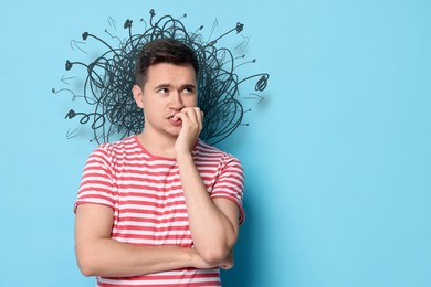 Image of Worried man on light blue background. Confused thoughts as doodles behind his head. Stress, anxiety, depression