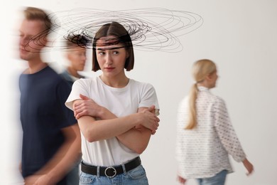 Image of Worried woman in room with people. Confused thoughts as lines around her head. Stress, anxiety, depression
