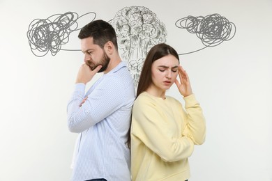Image of Worried man and woman on white background. Confused thoughts as doodles above their heads. Misunderstanding, stress, anxiety
