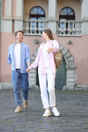Photo of Lovely couple walking together on city street