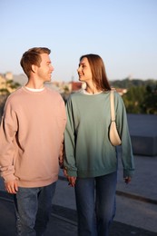 Photo of Lovely couple walking together on city street
