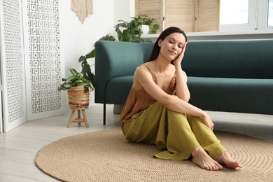 Photo of Harmony. Beautiful woman sitting on floor at home