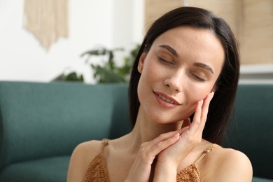 Photo of Harmony. Smiling woman enjoying moment at home