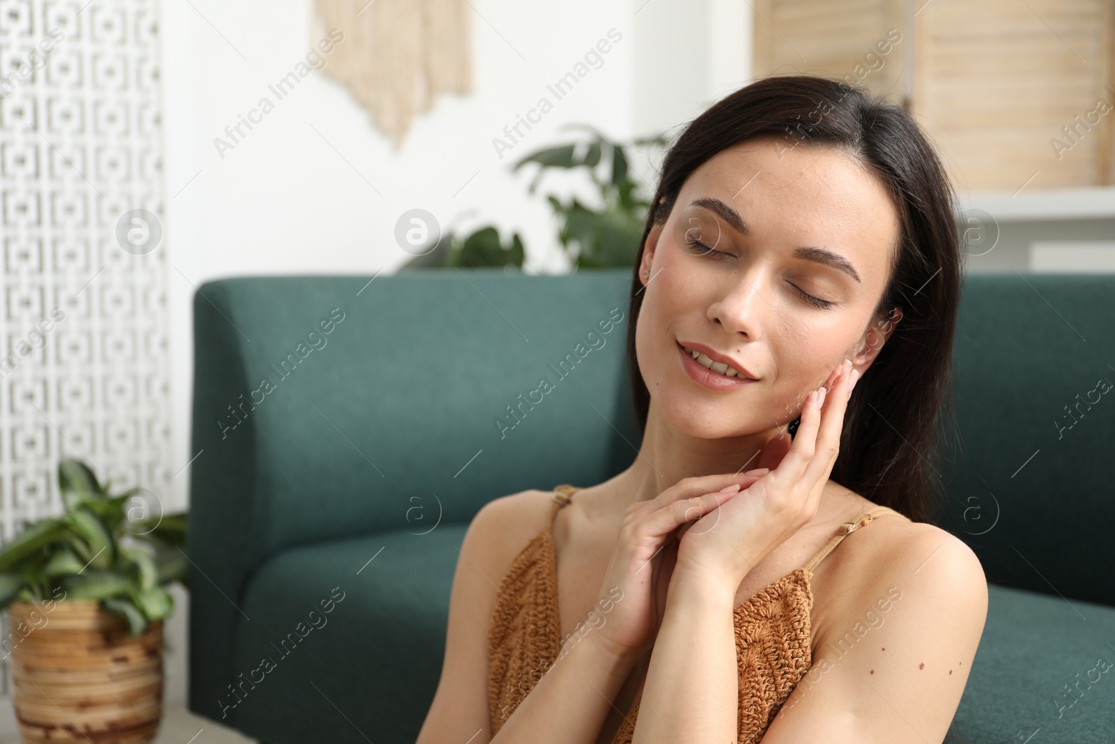 Photo of Harmony. Smiling woman enjoying moment at home