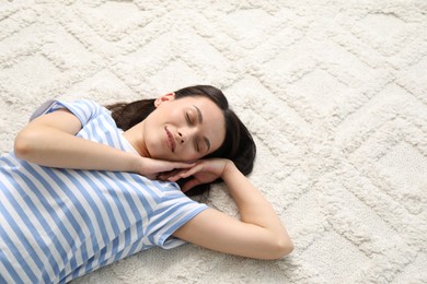 Photo of Harmony. Smiling woman lying on light carpet