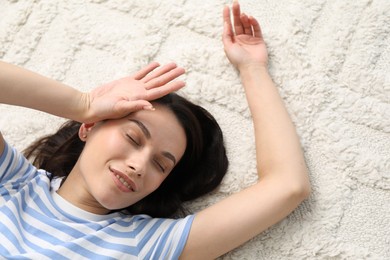 Photo of Harmony. Smiling woman lying on light carpet