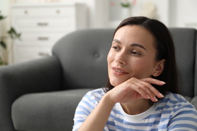 Photo of Harmony. Smiling woman at home, space for text