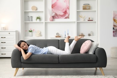 Photo of Harmony. Beautiful woman lying on sofa at home