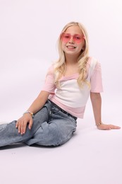 Photo of Little girl on white background in photo studio