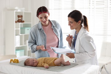 Photo of Mother and her cute baby having appointment with pediatrician in hospital