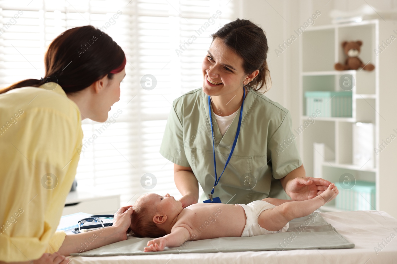 Mother and her cute baby having appointment with pediatrician in hospital Photo of Mother and her cute baby having appointment with pediatrician in hospital