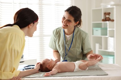 Photo of Mother and her cute baby having appointment with pediatrician in hospital