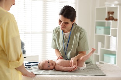 Photo of Mother and her cute baby having appointment with pediatrician in hospital