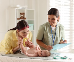 Photo of Mother and her cute baby having appointment with pediatrician in hospital
