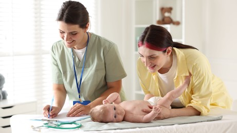 Photo of Mother and her cute baby having appointment with pediatrician in hospital