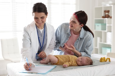 Photo of Mother and her cute baby having appointment with pediatrician in hospital