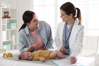Photo of Mother and her cute baby having appointment with pediatrician in hospital