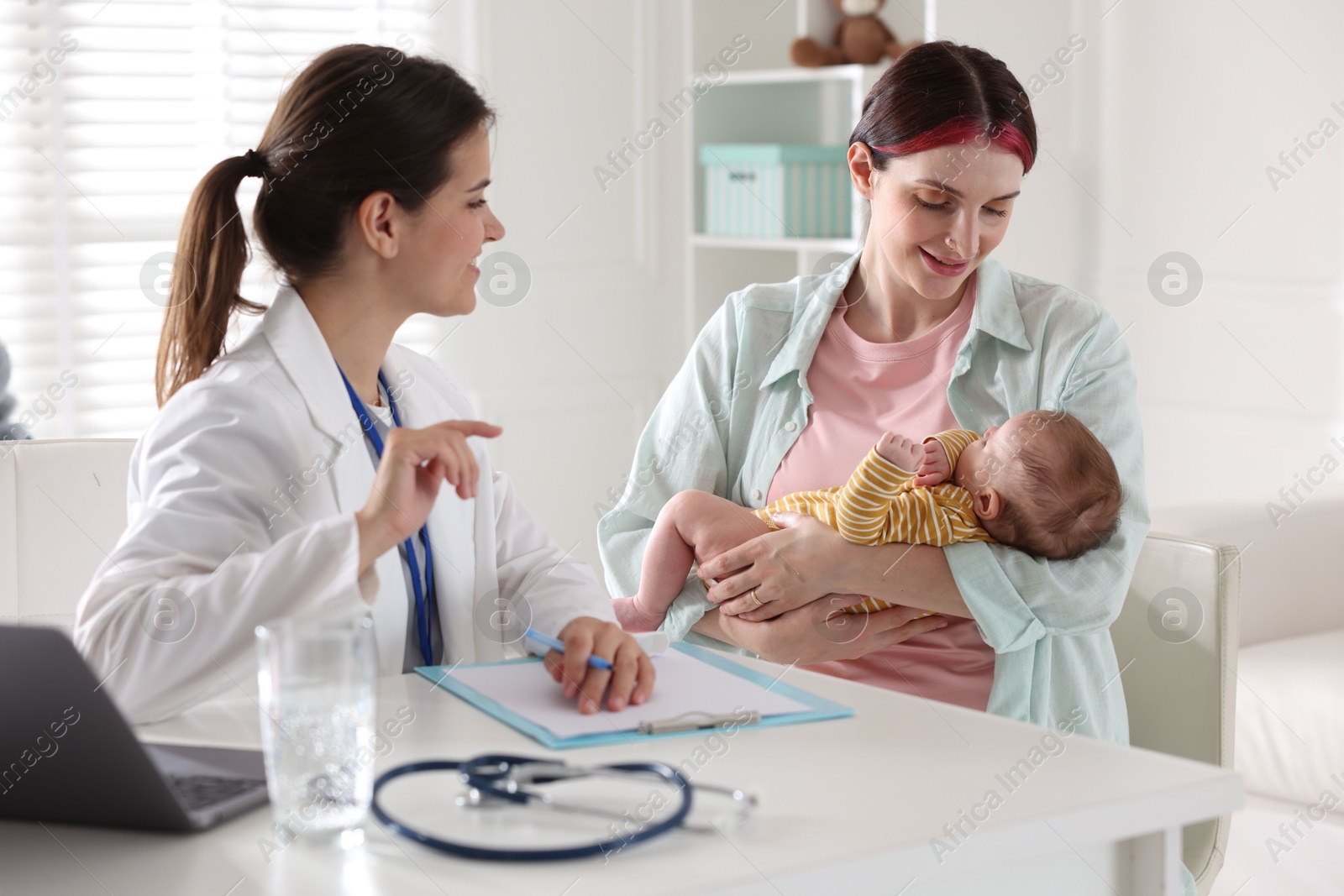 Mother and her cute baby having appointment with pediatrician in hospital Photo of Mother and her cute baby having appointment with pediatrician in hospital