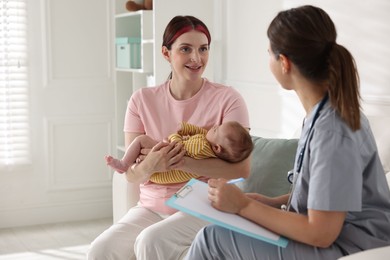 Photo of Mother and her cute baby having appointment with pediatrician in hospital