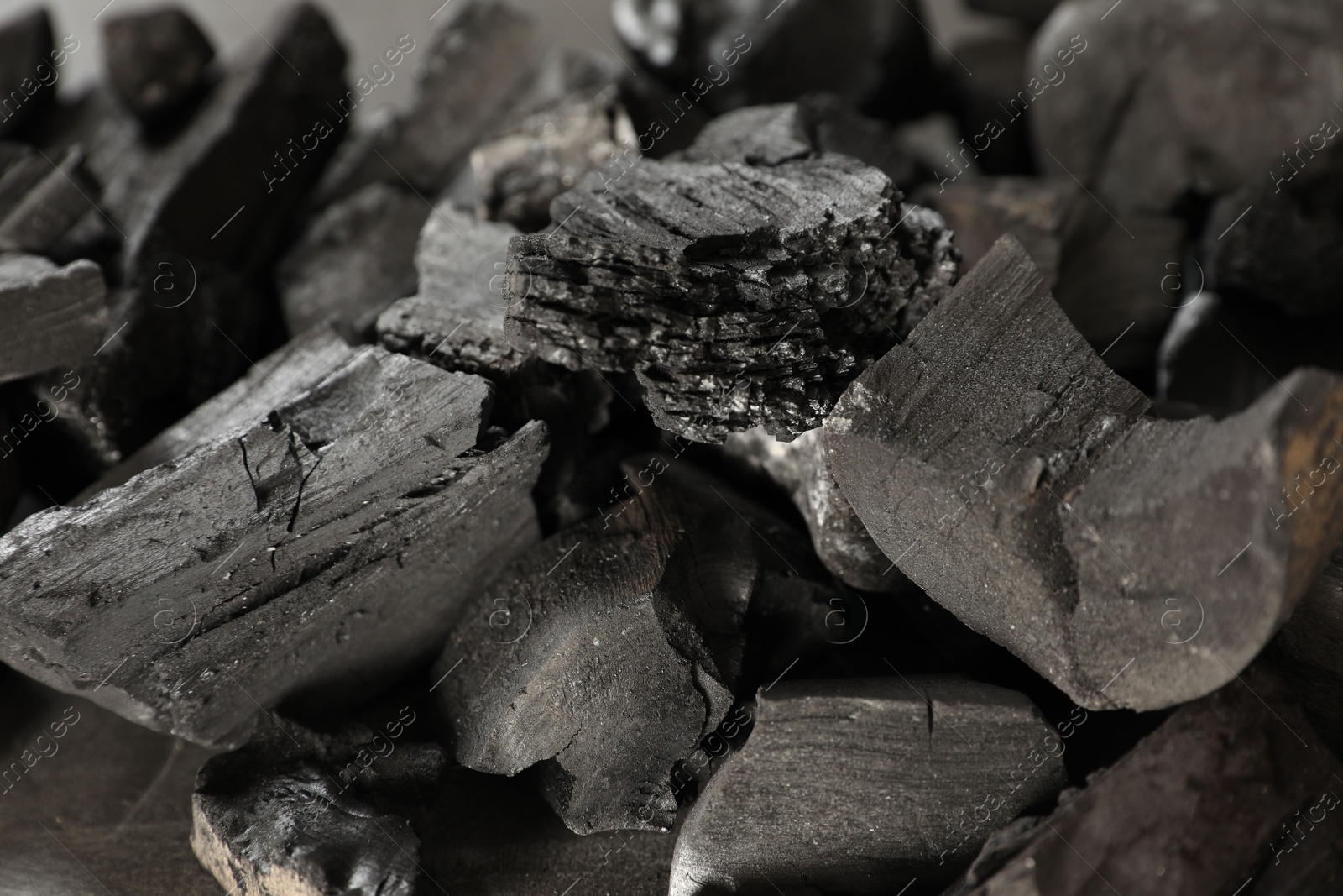Pieces of black coals on table, closeup Photo of Pieces of black coals on table, closeup